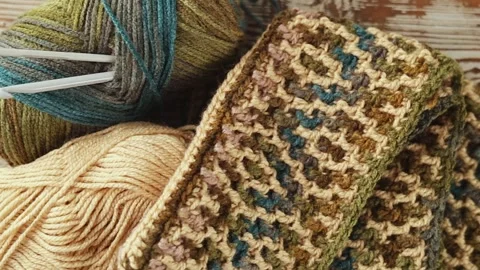 Mosaic Crochet Pattern with Yarn and Hook on Wood Stock Footage 344041843