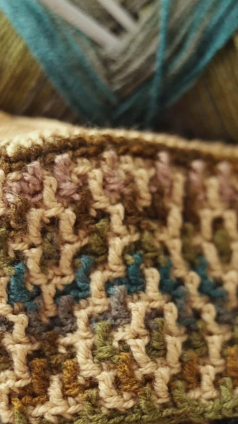 Mosaic Crochet Pattern with Yarn and Hook on Wood Stock Footage 344041865