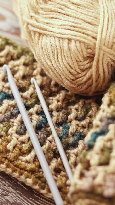 Mosaic Crochet Pattern with Yarn and Hook on Wood Stock Footage 344041867