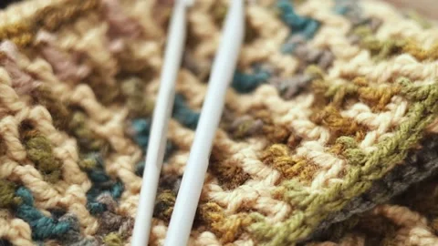 Mosaic Crochet Pattern with Yarn and Hook on Wood Stock Footage 344043717