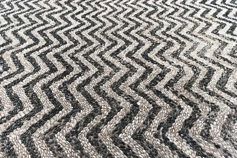 Mosaic ground pavement with striped pattern of black and white pebble stones Stock Photos