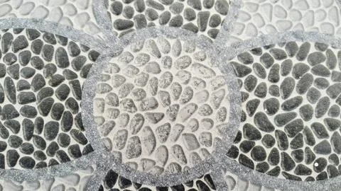 Mosaic pebble stone tile flooring texture background with floral pattern 스톡 사진
