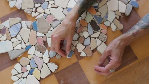Mosaic of small stones on the table. decorating the table with small pieces of 스톡 동영상 149280954