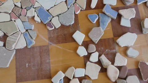 Mosaic of small stones on the table. decorating the table with small pieces of Stock-Footage 149423369