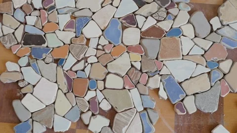 Mosaic of small stones on the table. decorating the table with small pieces of Stock-Footage 149423546