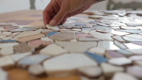 Mosaic of small stones on the table. decorating the table with small pieces of Stock-Footage 149540294