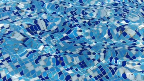 Mosaic squares tiles under small waves on transparent water. Slow motion Stock Footage 154328802