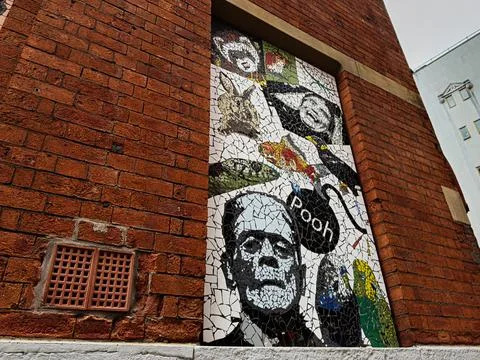Mosaic tile mural on brick wall in Manchester, UK featuring frankenstein sk.. 库存照片
