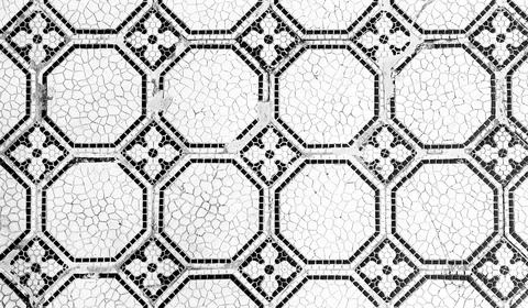 Mosaic tile pattern on a floor showing geometric shapes and black accents 스톡 사진