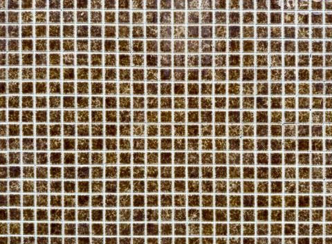 Mosaic tile pattern forms geometric grid. Small square ceramic brown tiles Stock Photos