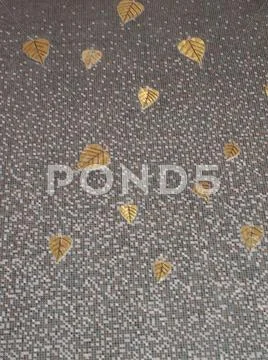 Mosaic tiles wall with golden bodhi leaves decoration Stock Photos
