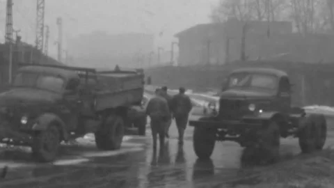 Moscow - 1971: Soviet workers jump off trucks on snowy street, during communism Stock Footage 280287489
