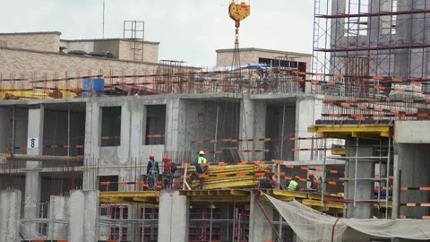Moscow, August 20 2026, Workers focus on construction work Stock Footage 343699176
