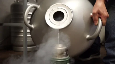 MOSCOW: CIRCA 2017: Pour liquid nitrogen in still cup in laboratory Stock Footage 81707472