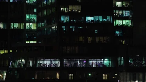 MOSCOW - CIRCA 2017: Time lapse of people moving in the windows of a skyscraper Video stock 85397554