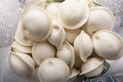 MOSCOW - DEC 20: Opened pack with frozen Russian dumplings or pel'meni Stock Photos