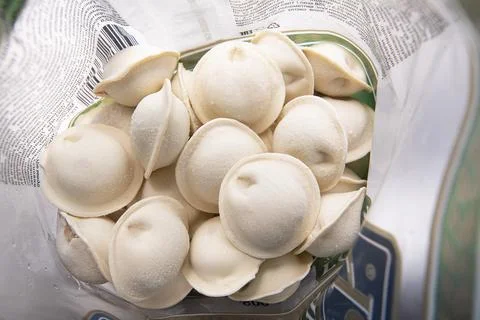 MOSCOW - DEC 20: Opened pack with frozen Russian dumplings or pel'meni Stock Photos