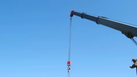 MOSCOW - JULY 28. The red hook of a construction crane hanging down from a boom  Stock Footage 123877262