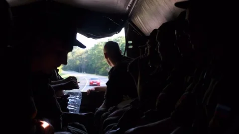 MOSCOW - JULY 30. A group of soldiers are driving in a truck. Inside view Stock Footage 118383653
