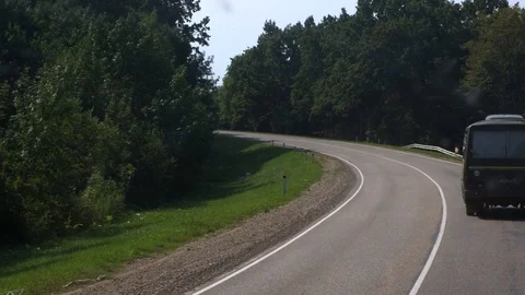MOSCOW - JULY 30. Soviet school bus rides on a road around the forest Stock Footage 118380979