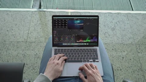 MOSCOW, RUSSIA - MAY, 17, 2021: Man working in Davinci Resolve app at Macbook. Stock Footage