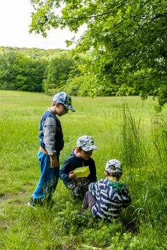 MOSINA, POLAND - May 30, 2021: Kids looking for something at a park Stock Photos
