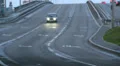 Moskvich Soviet Union car drives highway alone, lights on, dusk HD Footage