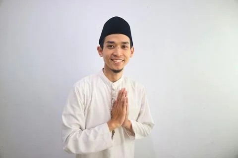 Moslem Asian man smiling at the camera with hand praying pose Stock Photos