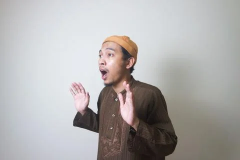 Moslem Asian man surprised expression looking to camera when Ramadan celebr.. Stock Photos