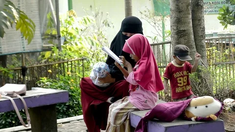 Moslem child Learning with mom Stock Footage 94511897