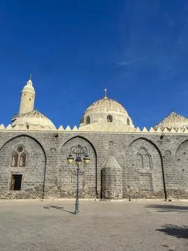 Mosque of Al-Ghamama with domes and minaret under clear blue sky. Stock Photos