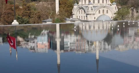 Mosque and Turkish flag reflected with gulls on a calm rooftop pool Stock Footage 320171091