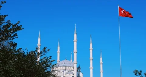 Mosque and Turkish flag. Turkish flag waving at blue sky with mosque minarets. Stock Footage 103997550