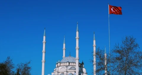 Mosque and Turkish flag. Turkish flag waving at blue sky with mosque minarets. Stock Footage 103997595