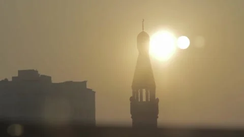 Mosque silhouette in sand storm with sun reflection Stock Footage 248892980