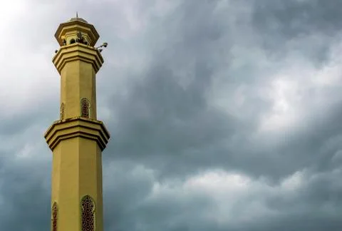 Mosque tower with cloudy skies Stock Photos