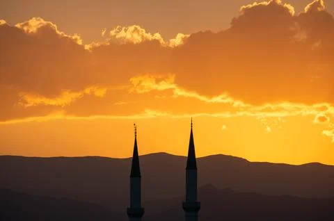 Mosque towers at sunset with clouds Foto stock