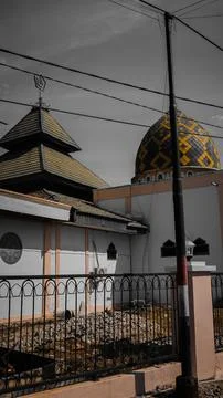 A mosque with a unique architectural design featuring a three-tiered roof a.. 스톡 사진
