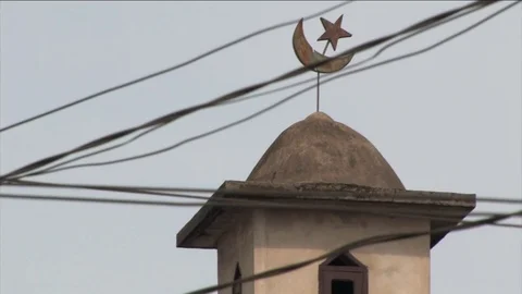 Mosque's star and crescent behind city cables Stock Footage 80458553