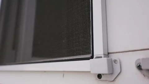 Mosquito Net Installed on White Window Frame Showing Corner Bracket Stock Footage 334735876