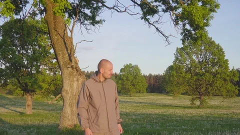 Mosquitoes and beetles attack a young tourist man near the evening forest field Video stock 111721642