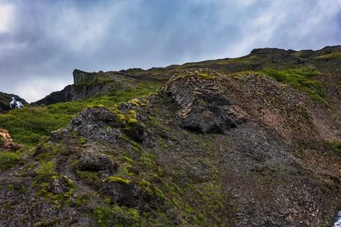 Moss-covered lava fields with columnar basalt formations in Iceland Stock Photos