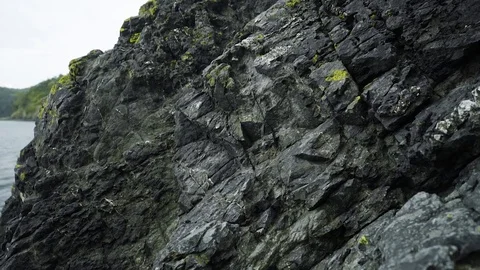 Moss covered shore rock at Deception Pass Bridge State Park Washington Stock Footage 73526920