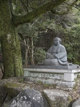 Moss-covered stone Buddhist statues in a temple forest, Japan Stock Photos