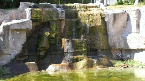Moss Covered Stone Waterfall With Cascading Water In Garden Stock Footage 345614808