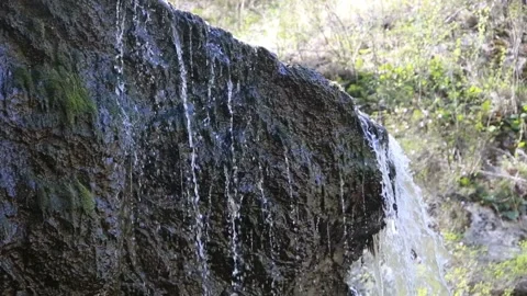 Moss Growing on Slippery Brown Rocks - Wet Slick Surfaces, small waterfall with Stock Footage 108300552