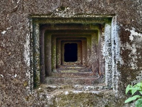 Mossy concrete ventilation shaft with nested square openings Stock Photos