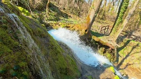 Mossy rocks cascade with rushing water. Mount Ozren Видео 330676991