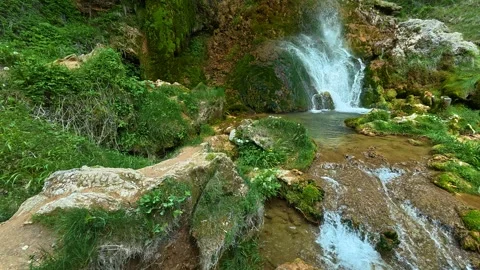 Mossy rocks frame a gentle waterfall cascade. Gostilje Waterfall, Serbia. Stock Footage 337061534