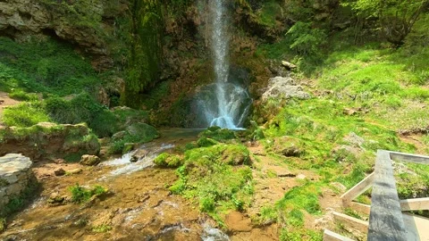 Mossy waterfall cascades into a rocky pool. Gostilje Waterfall, Serbia. Vídeos de archivo 337059934